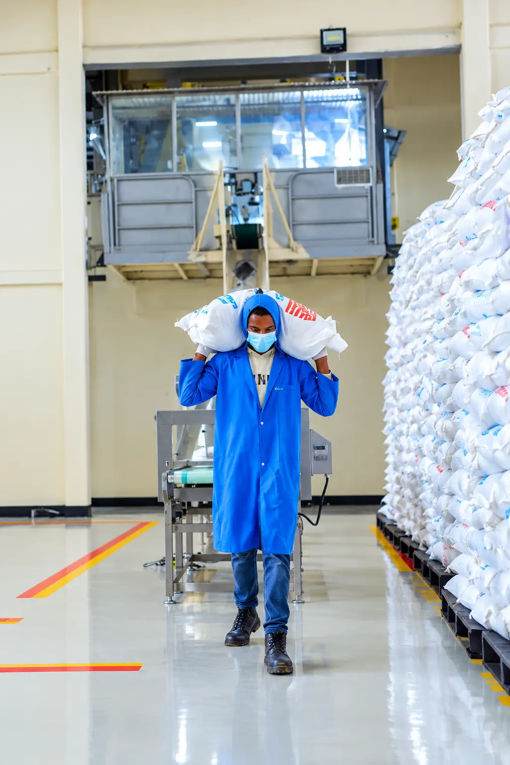 Quarit worker carrying packaged products through the clean processing hall