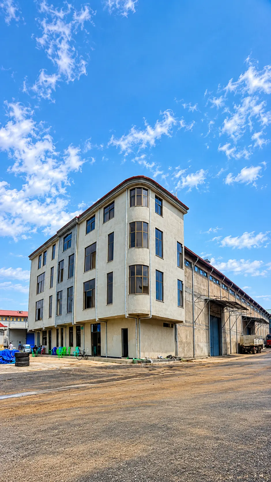 Exterior of the Quarit Agro Industry processing facility under a blue sky
