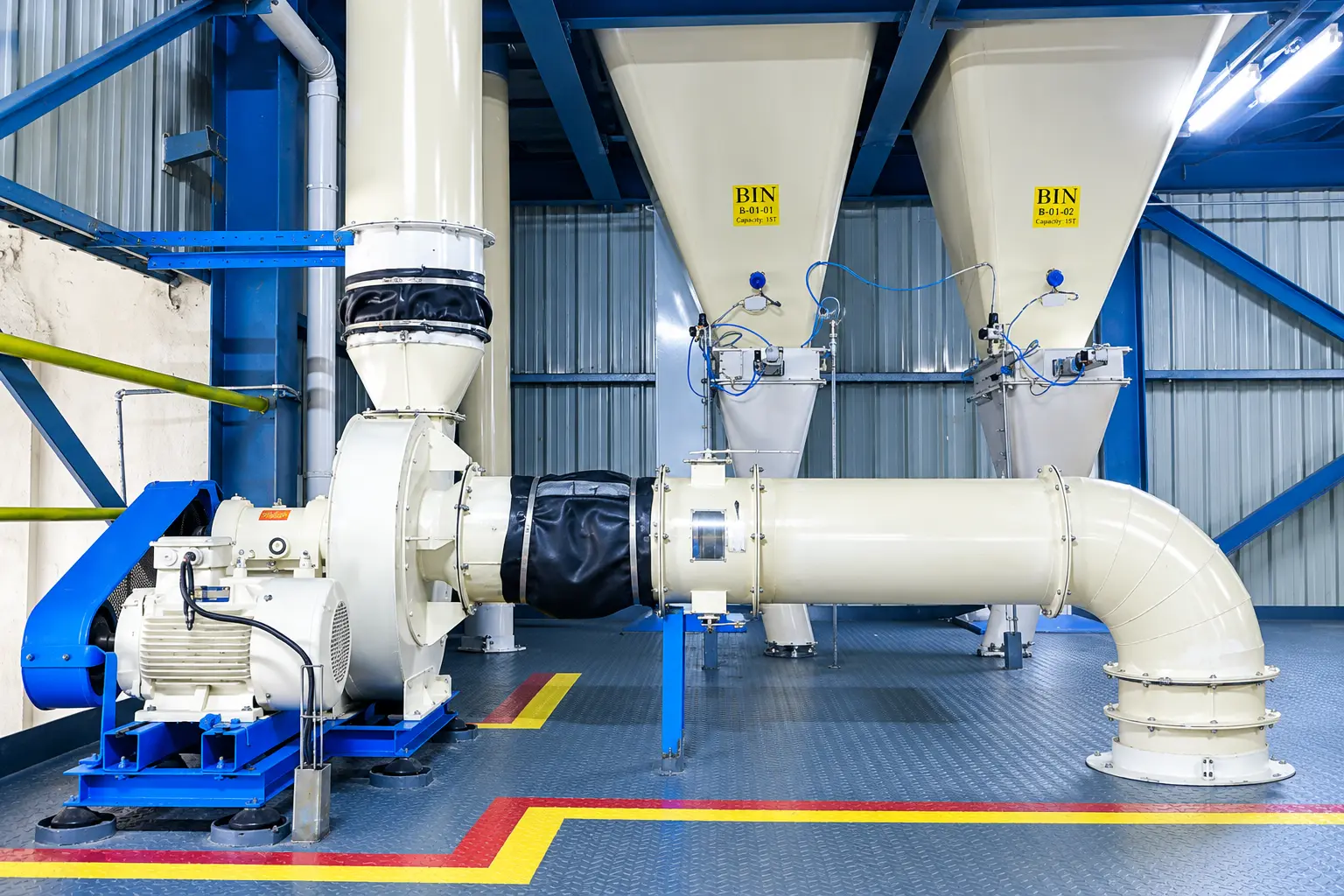 Pneumatic conveying ducting and blower moving material between processing stages